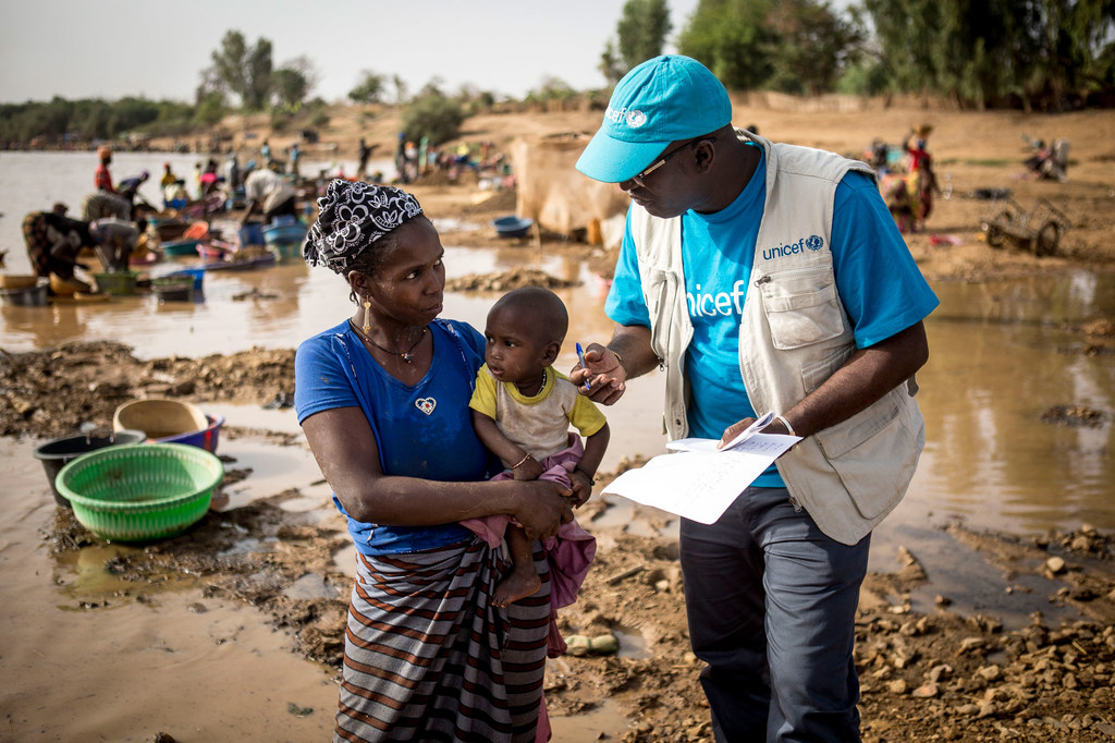 UNICEF/Seyba Keïta Un conseiller de l'UNICEF sur le terrain à Kayes, au Mali, explique à une mère à quel point il est important de vacciner son enfant. (Mars 2019