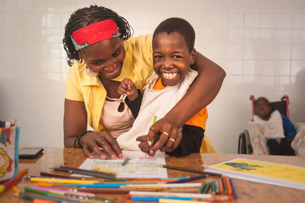 © UNICEF/Amminadab Jean Filomena, 8ans, née avec une tétraplégie spasmodique et une épilepsie, et sa mère colorient des dessins au centre de réadaptation psychosociale de Maputo, au Mozambique. (8 octobre 2018)